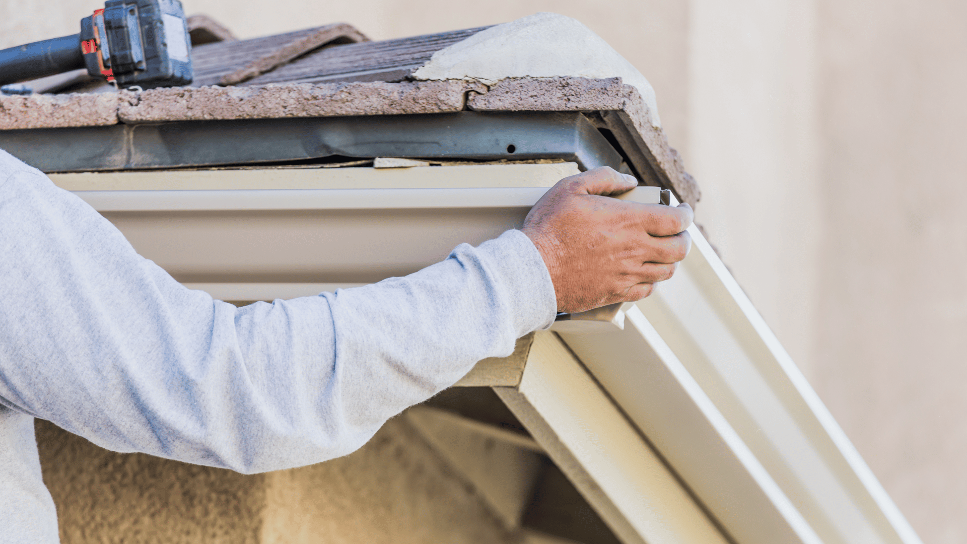 Gutter technician fixing a leak between gutter and fascia board