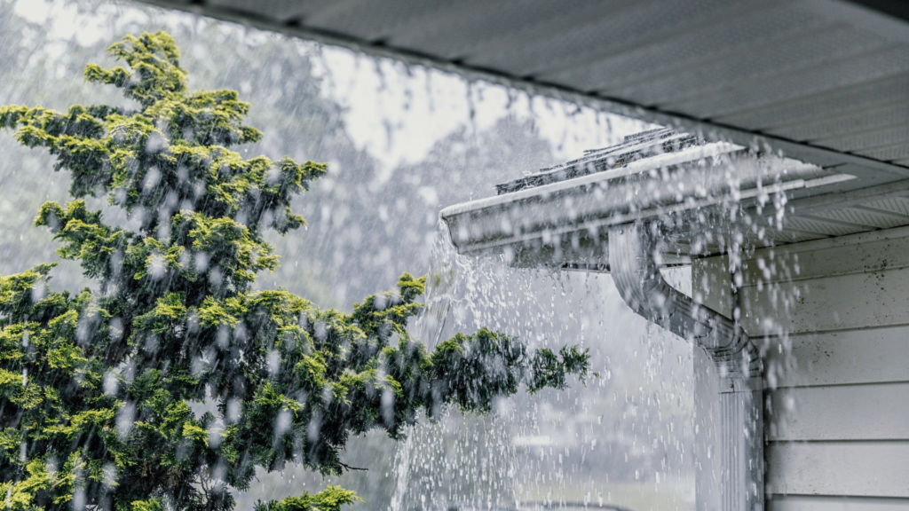 Neglected gutter maintenance causing overflowing gutters in storm