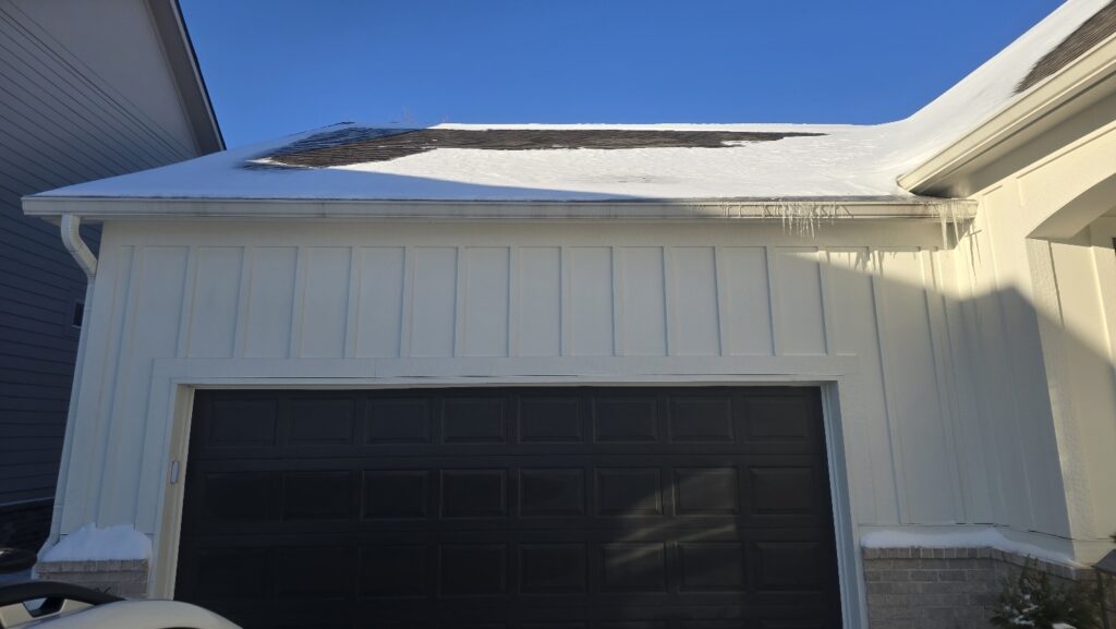 Snow in the gutters by the garage